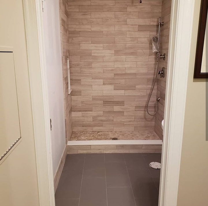 natural stone shower with pebble floor